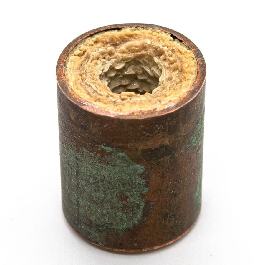 Mineral scale buildup restricting water flow inside a pipe